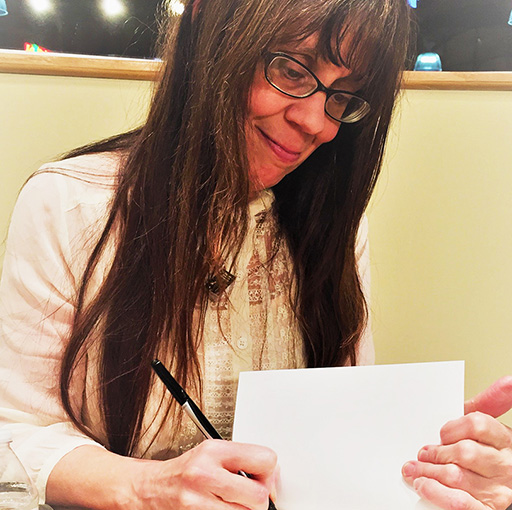 Author, Kate E Thompson, signs books at a local author signing